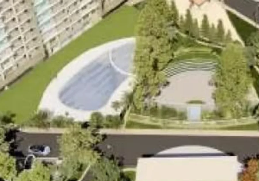 Swimming pool and open air theatre in the central park at Sahu City Pearl